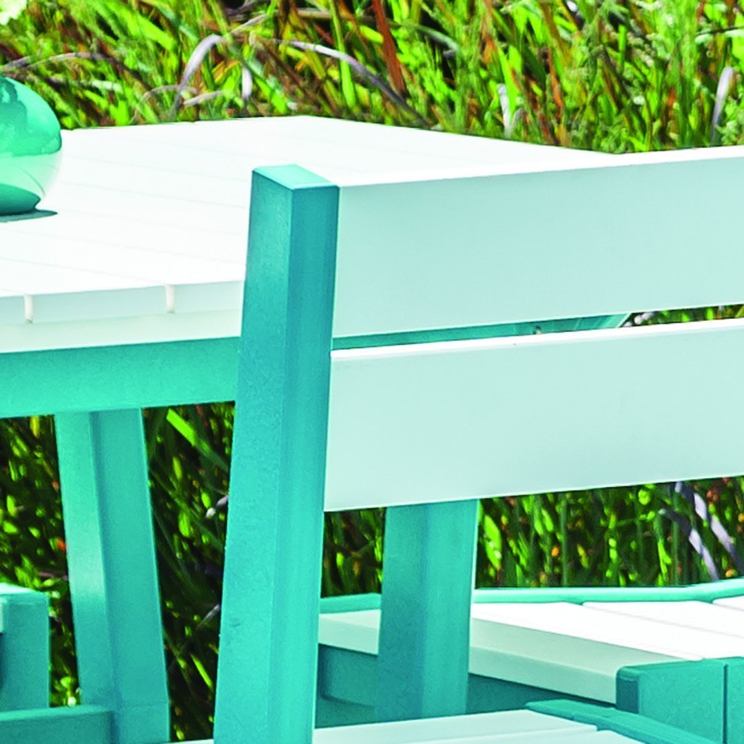 Aqua blue and white outdoor furniture set featuring a sleek, modern design against a vibrant green backdrop.