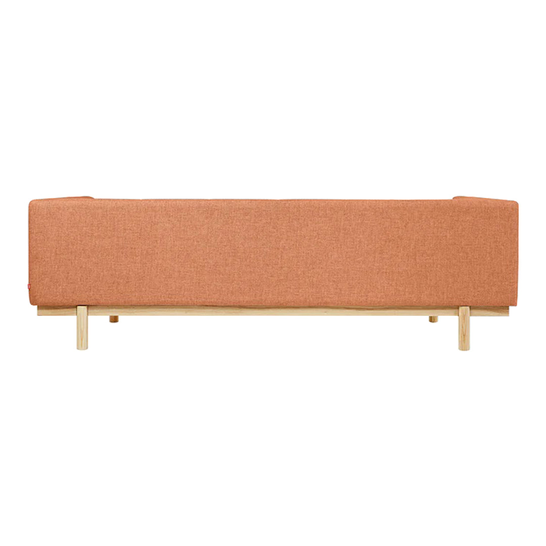 Orange upholstered sofa with a minimalist design and natural wood legs, offering a modern aesthetic for any space.