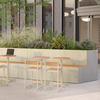 Minimalist seating design featuring light wood and soft beige tones against a lush green backdrop.