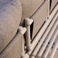 Gray textured fabric with white tubular accents and sleek lines, showcasing modern design and minimalist style.