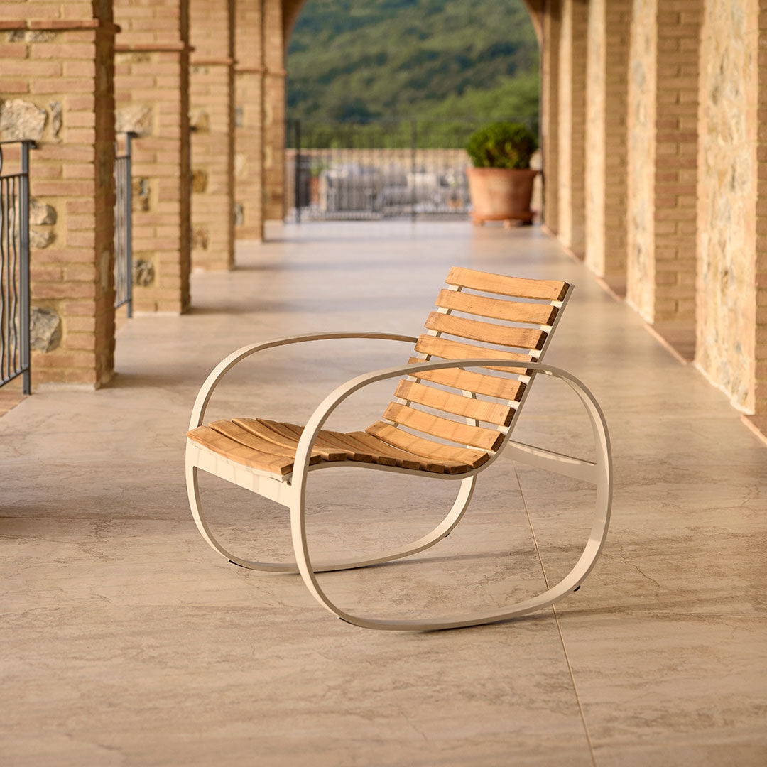 Light wood slats on a sleek white metal frame, resting on a textured stone floor. Elegant, minimalistic design.
