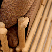 Brown textured upholstery with natural wood accents and clean lines, showcasing a modern, minimalist design.