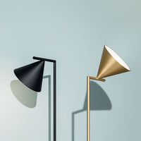 Black and gold modern lamps with sleek, conical shades against a soft blue wall. Minimalistic design and elegant contrast.