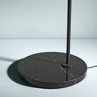 Black marble lamp base with white veining, sleek design complements modern decor. Perfect for stylish interiors.