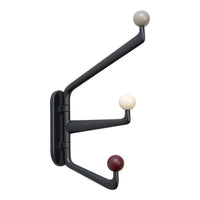 Modern black coat rack with three colorful round hooks in beige, cream, and burgundy, featuring a sleek minimalist design.