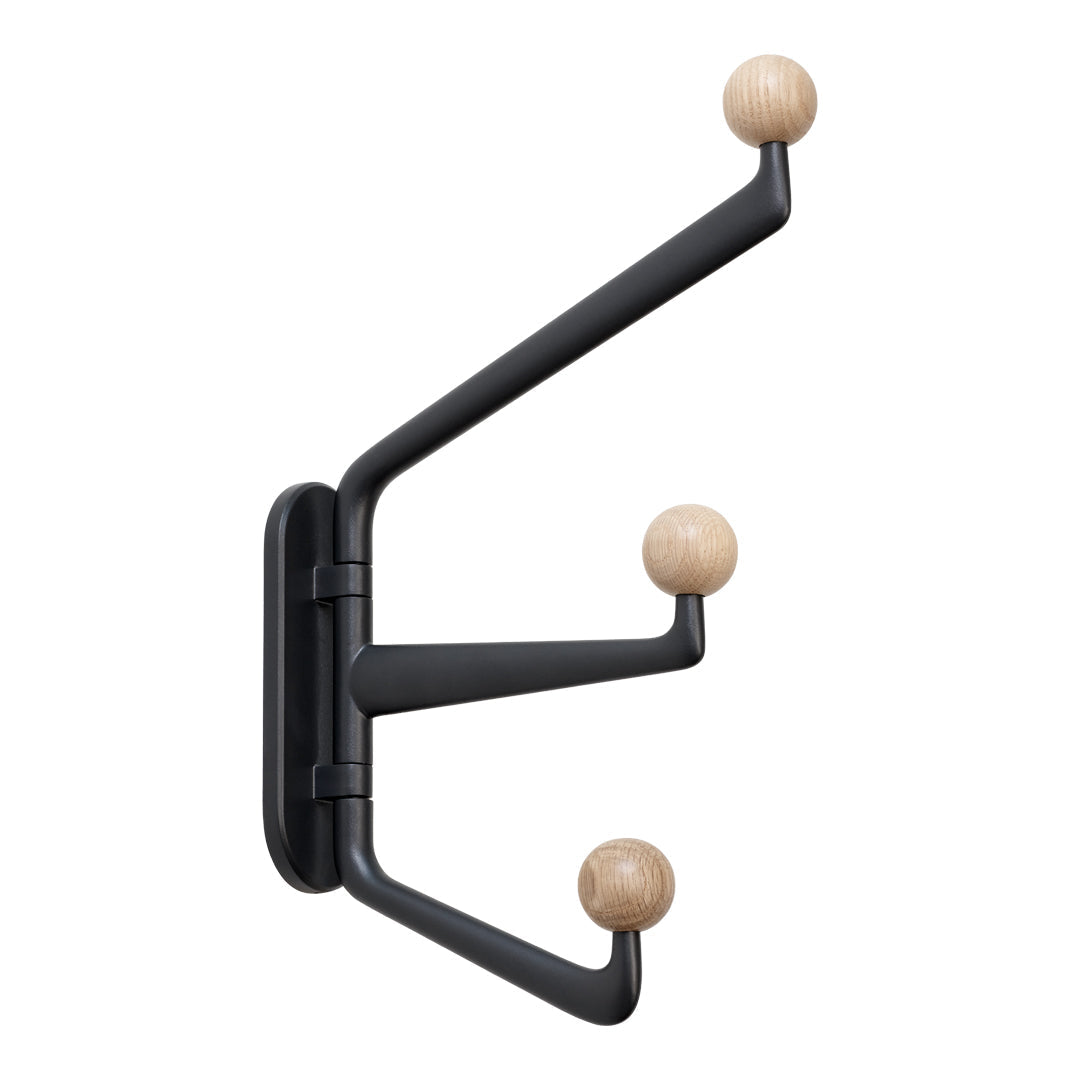 Black wall-mounted coat rack with natural wooden knobs, featuring a sleek, modern design.