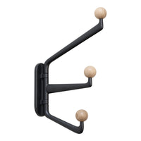 Black wall-mounted coat rack with natural wooden knobs, featuring a sleek, modern design.