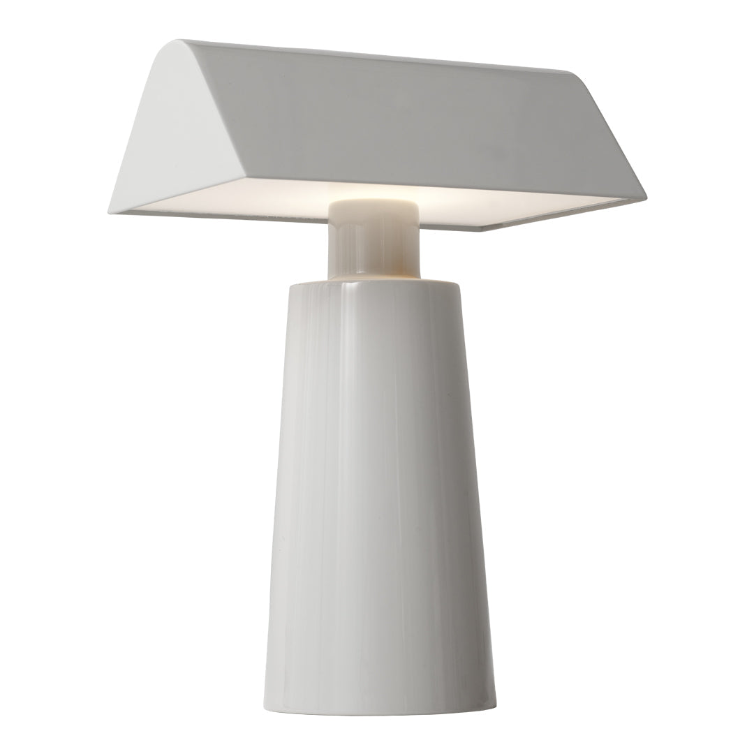 Modern white table lamp with a smooth, glossy finish and geometric shapes. Perfect for minimalistic decor.