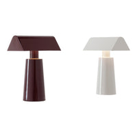 Two modern table lamps: one in rich burgundy, the other in clean white, featuring sleek geometric shapes.