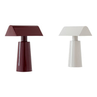 "Modern table lamps in deep burgundy and clean white with geometric shapes and glossy finishes."