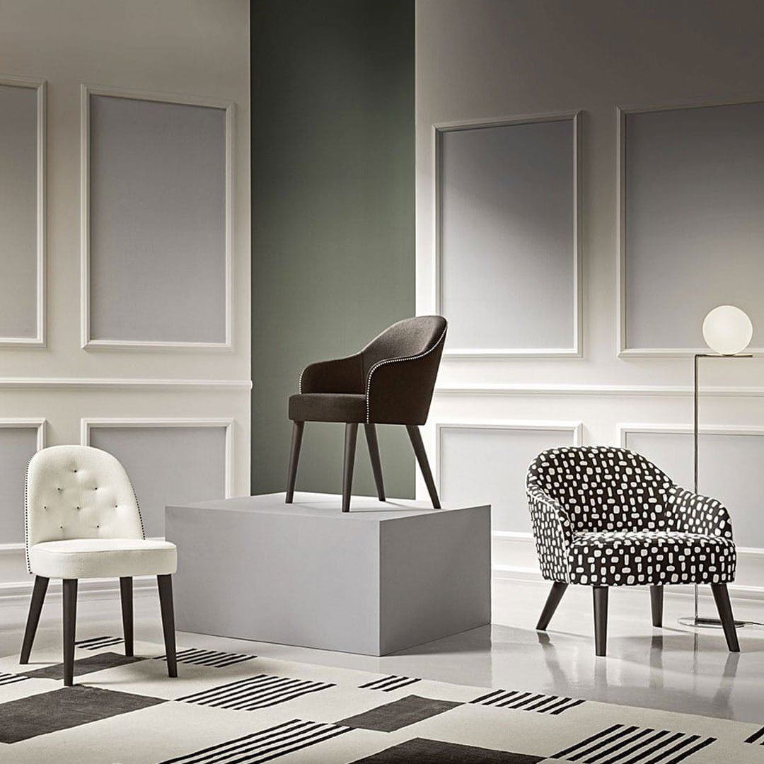 Stylish chairs in black, white, and patterned upholstery, featuring elegant designs against a modern backdrop.