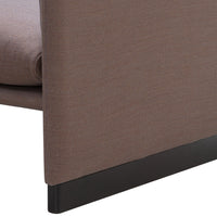 Brown fabric sofa corner with a smooth texture and a sleek black base. Subtle, modern design for any living space.