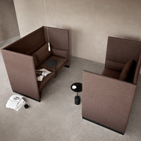 Brown upholstered seating with clean lines and minimalist design in a neutral-toned setting.