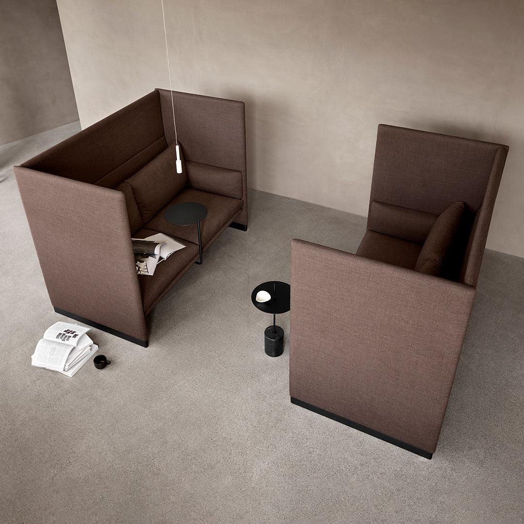 Brown fabric seating pods with minimalistic design, featuring solid surfaces and clean lines against a neutral background.