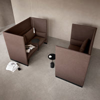 Brown fabric seating pods with minimalistic design, featuring solid surfaces and clean lines against a neutral background.