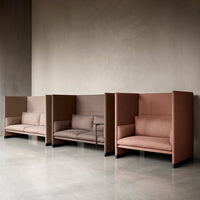 Three contemporary sofas in warm taupe and muted pink tones with smooth, minimalist upholstery patterns.