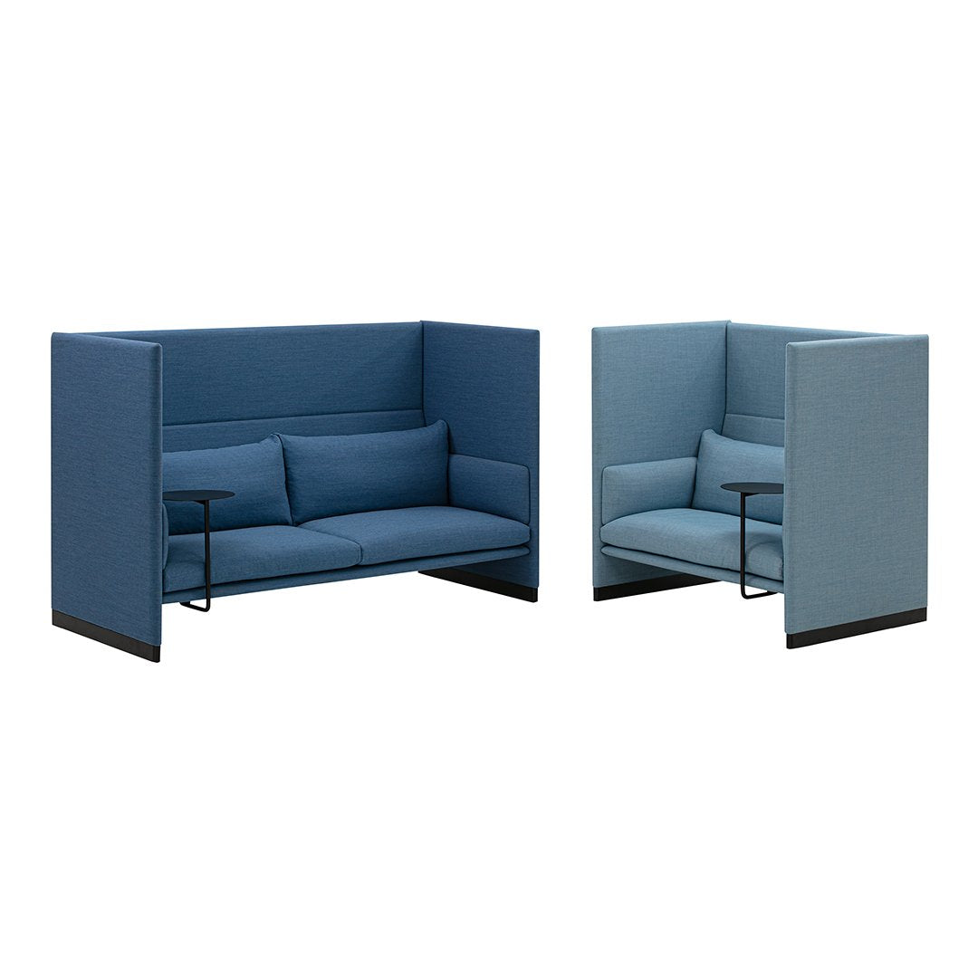 Blue upholstered sofa with sleek design; features textured, solid pattern and contrasting dark armrest.