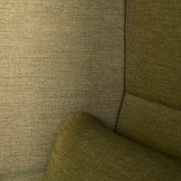 Textured green fabric in a soft, muted hue, featuring subtle interwoven patterns for a cozy aesthetic.