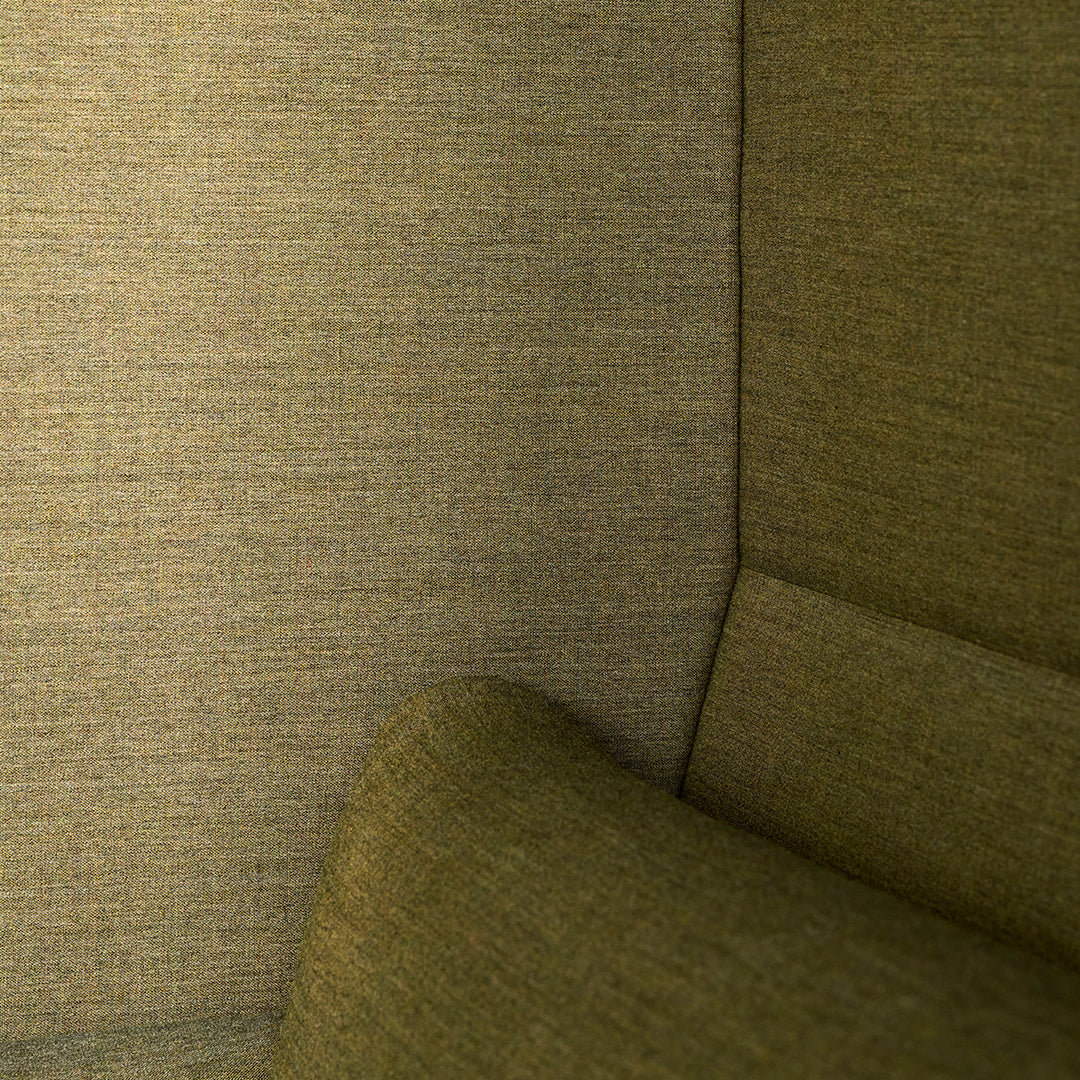 Textured olive green fabric with a subtle weave pattern, ideal for modern upholstery and interior decor.