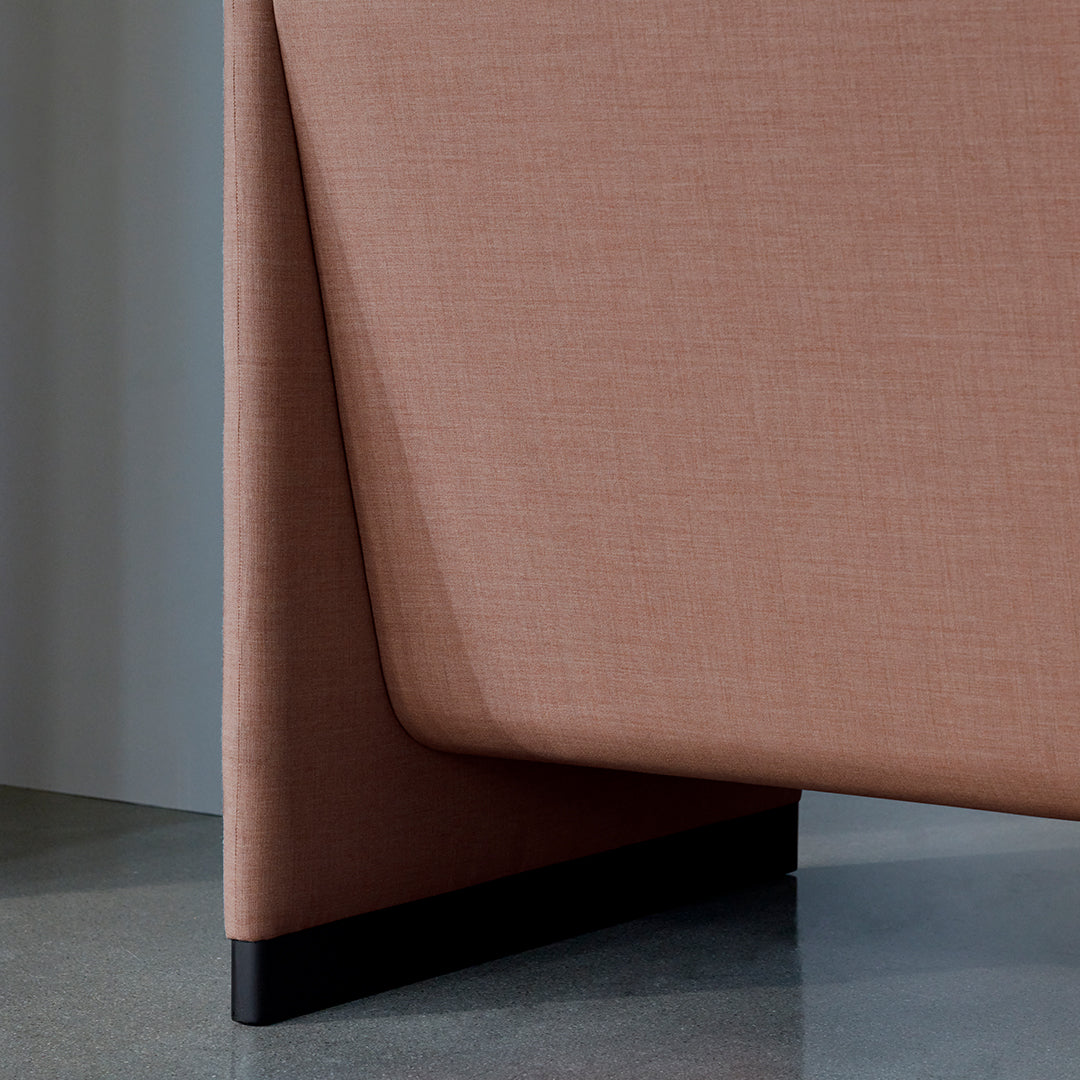 Soft pink fabric with a subtle texture, featuring sleek black legs for a modern accent. Perfect for contemporary decor.