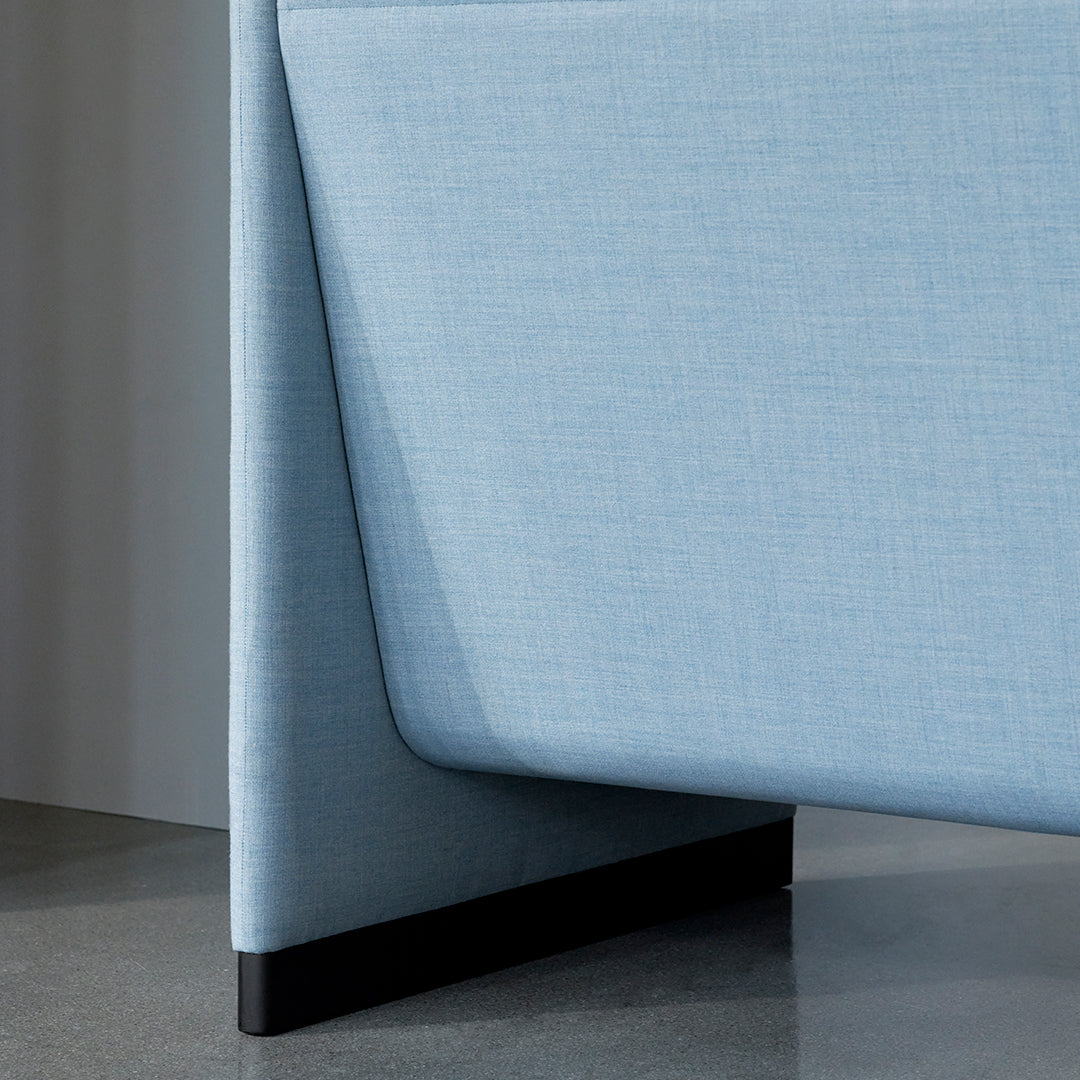 "Light blue textured fabric with a sleek black base, featuring a modern geometric design."