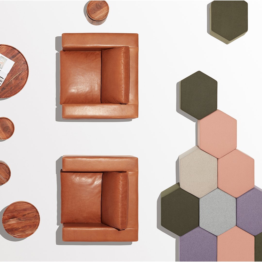 "Two brown leather chairs and hexagon tile pattern in muted shades of green, pink, and gray on a white background."