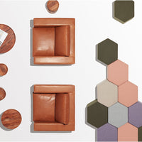 "Two brown leather chairs and hexagon tile pattern in muted shades of green, pink, and gray on a white background."