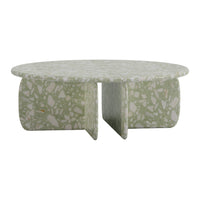 Round coffee table in light green with a textured, speckled pattern. Minimalist design complements modern decor.
