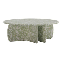 Round coffee table in soft green with a textured, speckled pattern, perfect for modern decor.