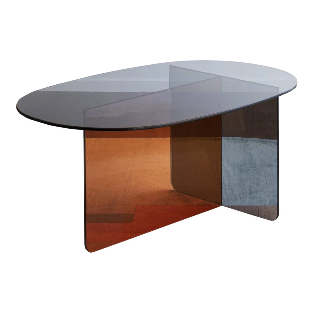 Modern oval coffee table with layered transparent surfaces in smoky gray, amber, and clear tones. Unique geometric design.