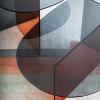 Geometric design featuring circular shapes in shades of gray, rust, and muted greens, with layered textures and patterns.