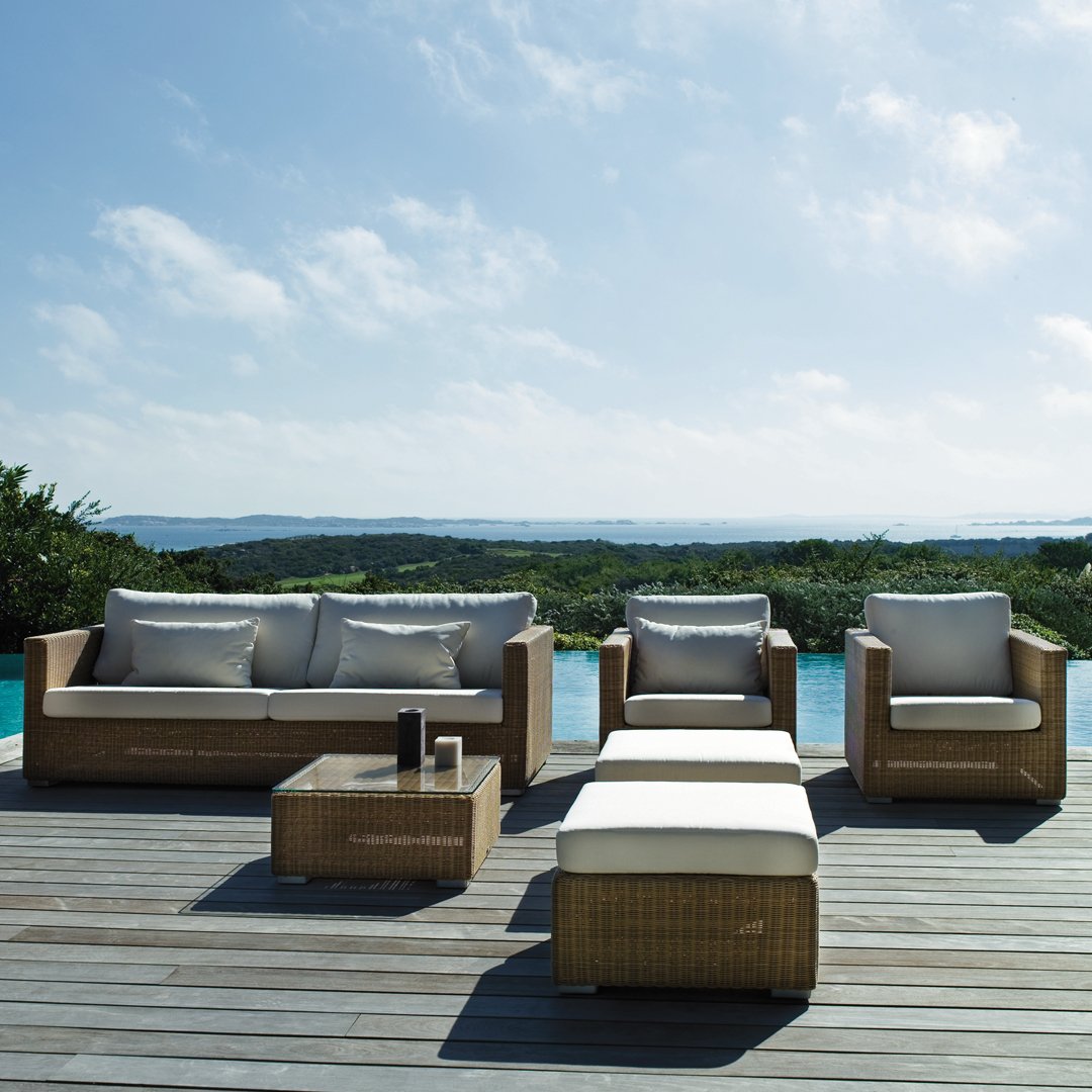 Stylish outdoor furniture set in natural wood tones and light beige cushions against a serene landscape backdrop.