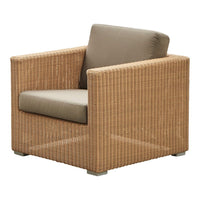 Tan wicker armchair with a beige cushion, featuring a sleek, modern design. Ideal for indoor or outdoor use.