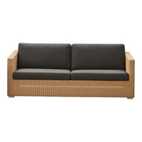 "Natural rattan sofa with dark gray cushions and woven pattern accents, ideal for modern outdoor spaces."