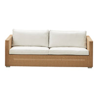 Light beige cushions paired with a woven tan rattan frame, offering a modern and neutral aesthetic.