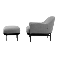 Gray textured armchair and matching ottoman on black legs. Simple, modern design with a stylish pattern.