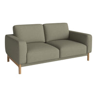 Light olive green sofa with a smooth, textured fabric and minimalist wooden legs. Modern, stylish design for any room.