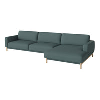 Teal fabric sectional sofa with clean lines and light wood legs, perfect for modern living spaces.