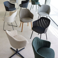 Variety of modern chairs in neutral tones, black, green, and textured fabrics, showcasing stylish patterns and designs.