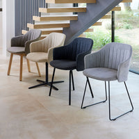 Set of four modern chairs in various colors: gray, cream, beige, and black with ribbed patterns. Stylish and versatile design.