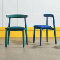 Two stylish chairs in deep teal and vibrant blue, featuring solid colors and a modern design against a bright yellow backdrop.