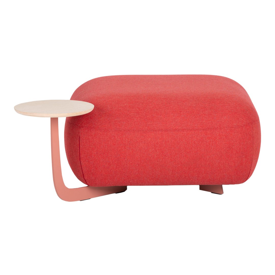 Red upholstered ottoman with a smooth, rounded shape and a sleek, light-colored side table attachment.