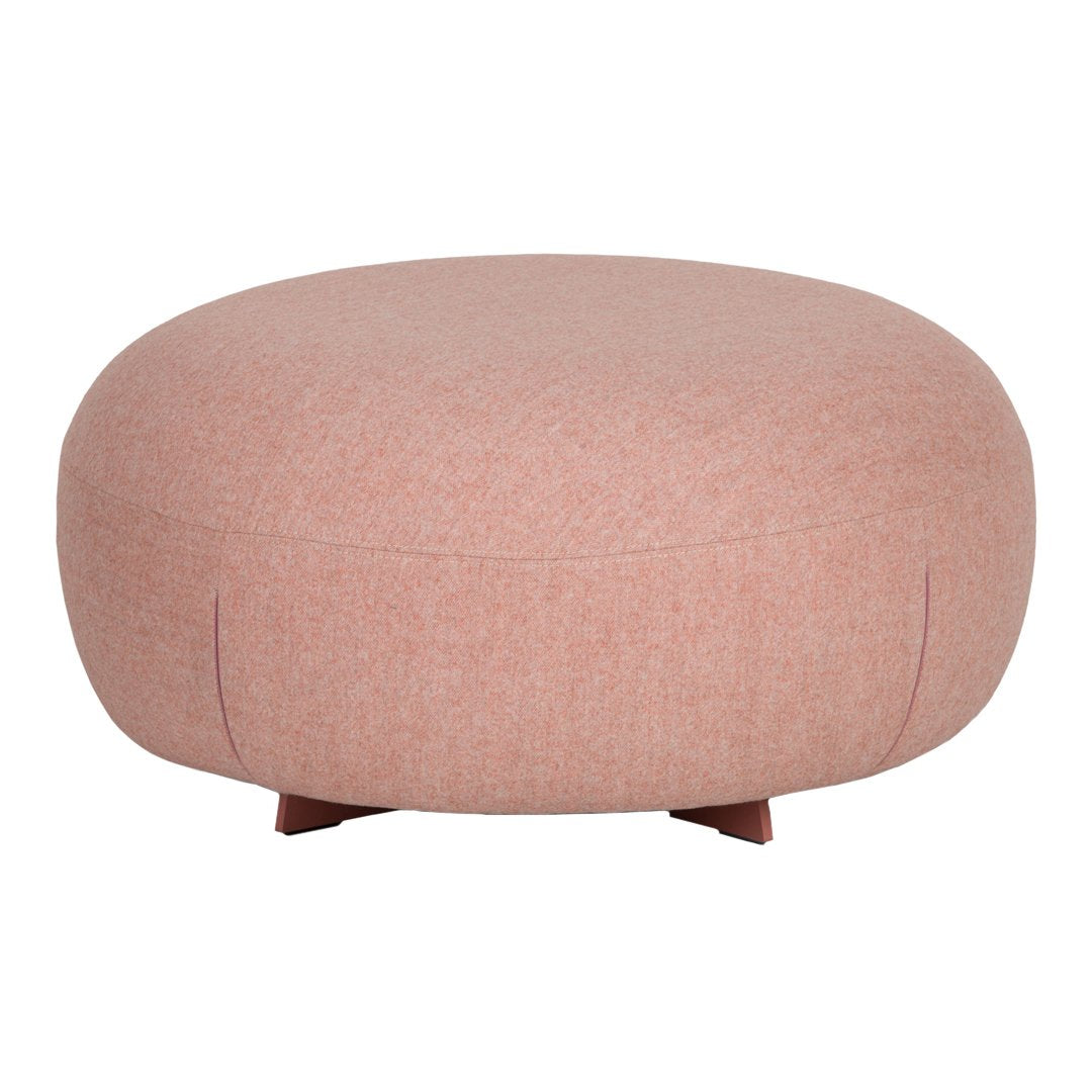 Round ottoman in soft blush pink fabric, featuring a smooth, minimalist design without patterns.
