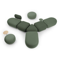 Modern modular seating in muted green tones with smooth, rounded shapes and a minimalist design.