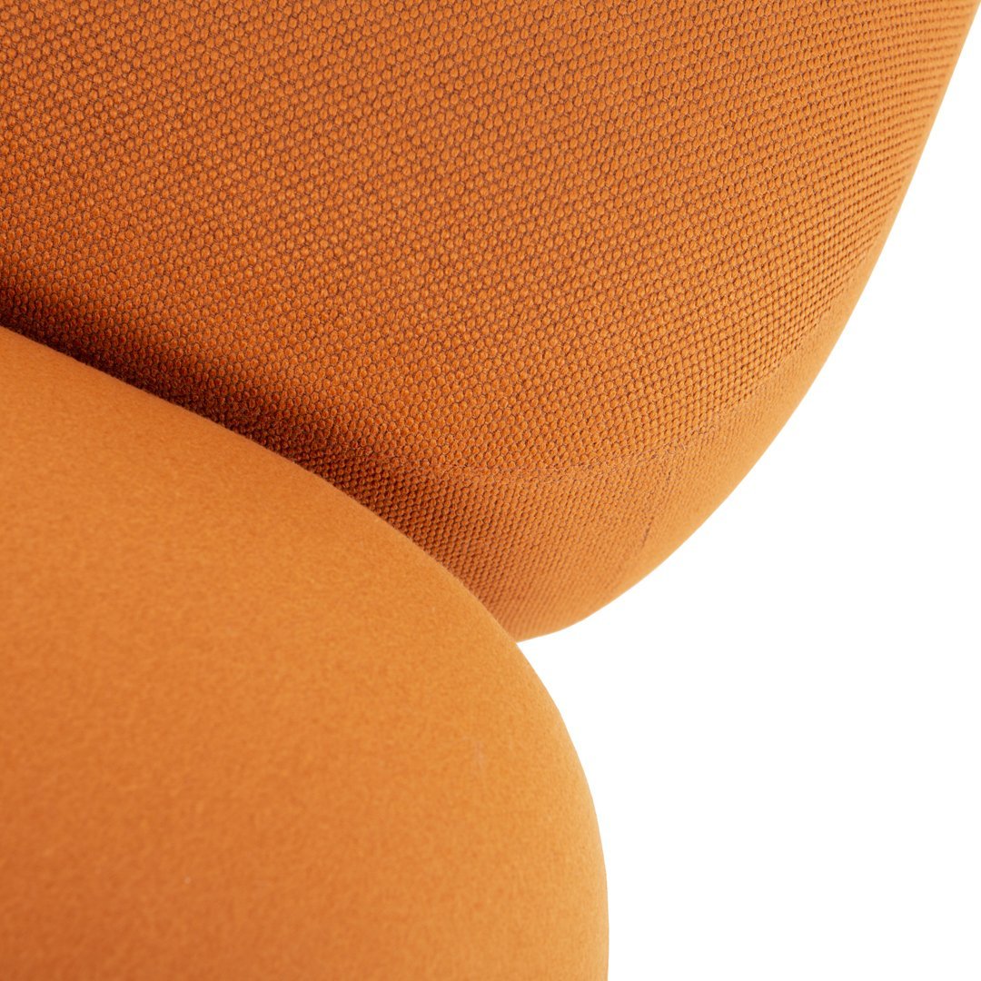 Bright orange textured fabric with smooth curves and contrasting shades. Ideal for modern decor.