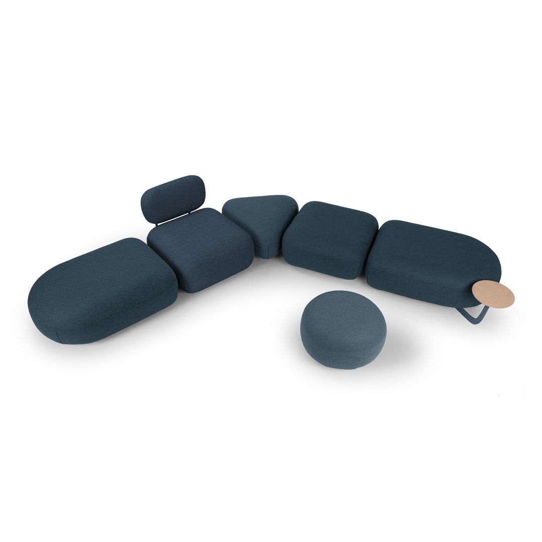 Modern modular sofa in deep navy blue, featuring various rounded shapes and smooth textures for a sleek, cohesive look.