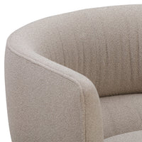 Beige curved armchair with textured fabric and subtle vertical patterns for a modern, minimalist look.