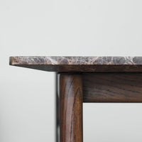 Elegant brown marble tabletop with subtle white veining, supported by rich dark wood legs. Perfect for modern décor.