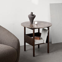 "Round marble top side table with dark wood frame, featuring neutral tones and smooth textures."