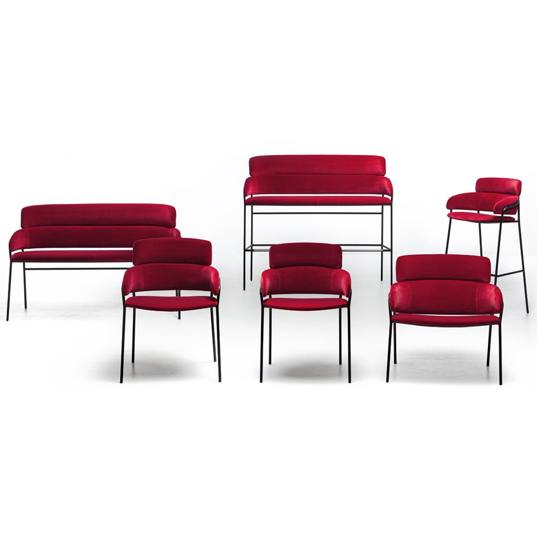 Set of red upholstered chairs in various styles, featuring sleek black metal legs. Stylish and modern design.